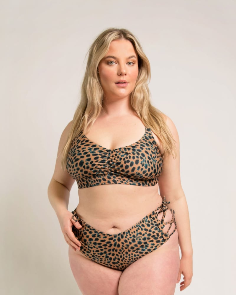 Front of a model wearing a size 14|16 Lola Side-Tie Bottoms in Cheetah by Wild Isles Swim. | dia_product_style_image_id:284911